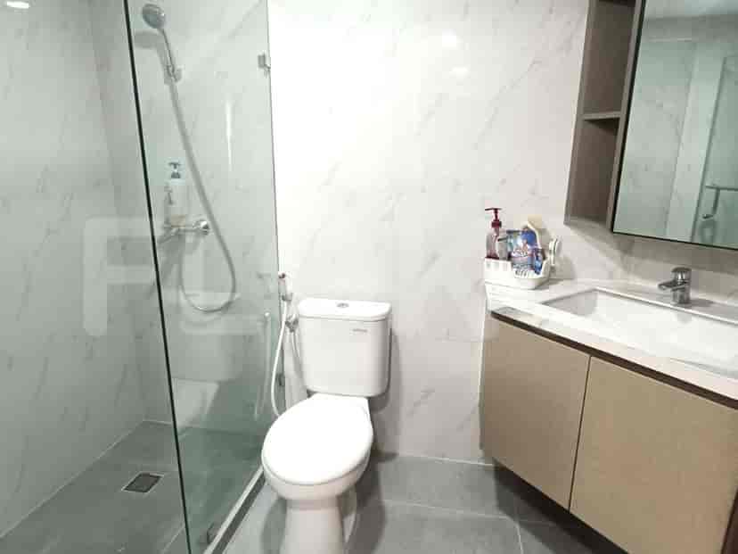 A modern bathroom with a walk-in shower, a toilet, a sink, and a vanity.