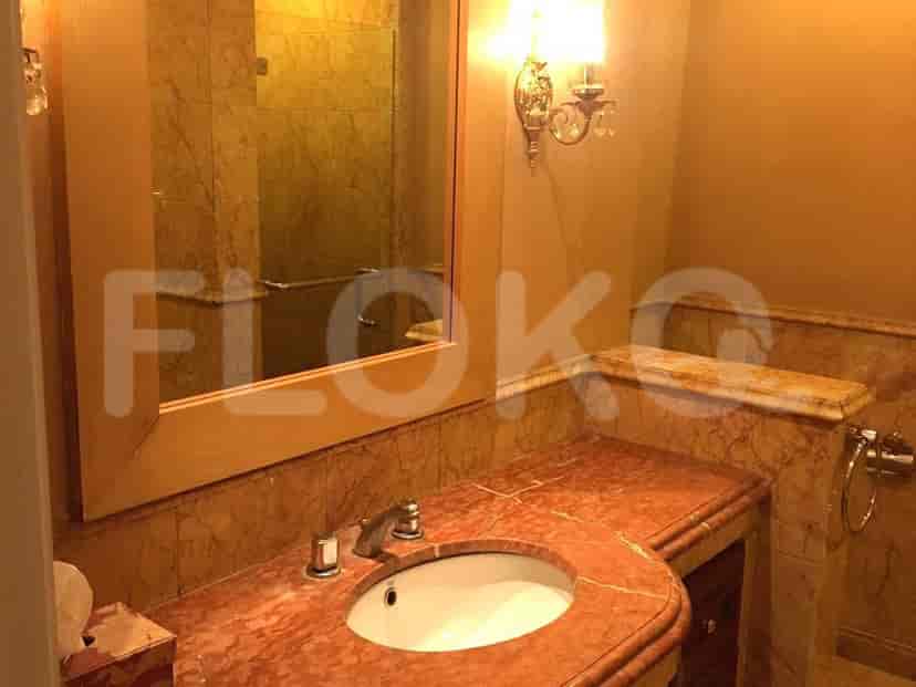 A bathroom with a marble countertop, a sink, and a mirror.