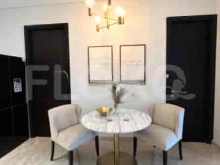 A small dining area with a marble-top table and two chairs.