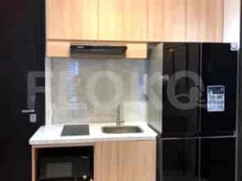 A compact kitchenette with appliances and cabinetry.