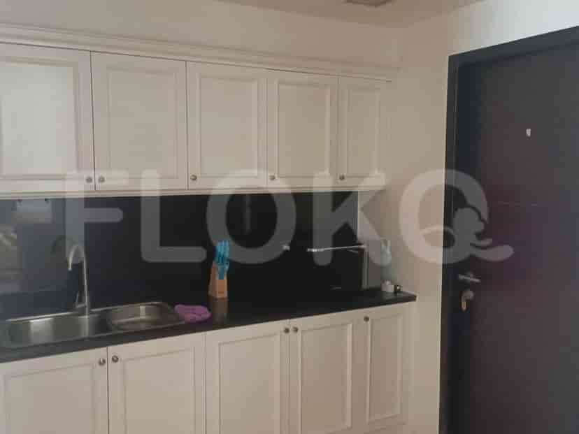 A modern kitchen with white cabinets, a dark countertop, and a sink.