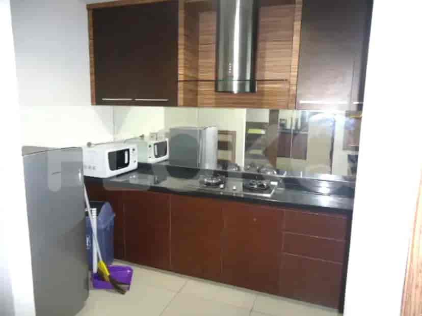 Dapur modern dengan lemari kayu, meja granit, dan peralatan built-in.