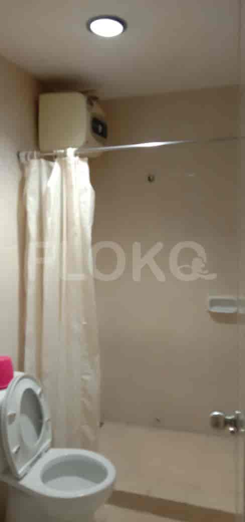 A bathroom with a toilet and shower.