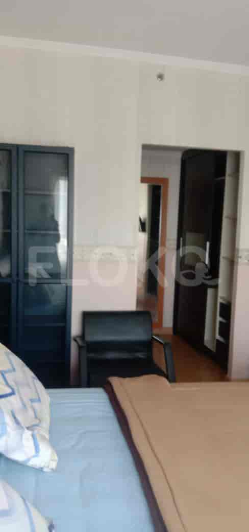 Bedroom with bed, chair and closet.