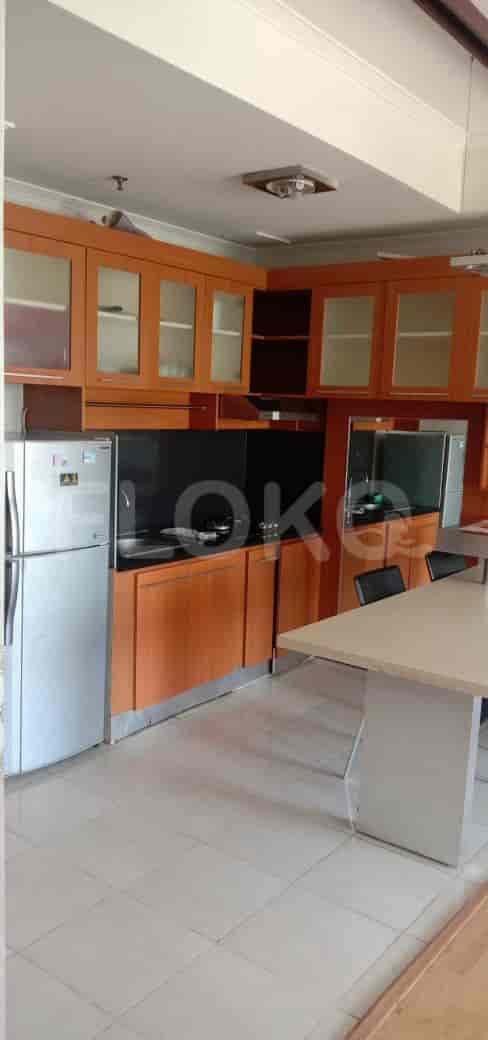 A kitchen featuring cabinets, appliances, and a dining table.