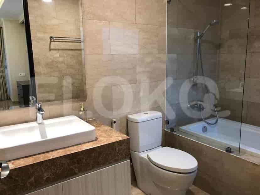 Bathroom with a bathtub, glass door, and modern design.