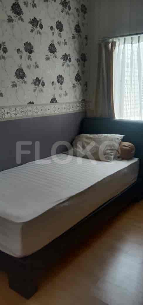 A bedroom with a single bed and a minimalist design.