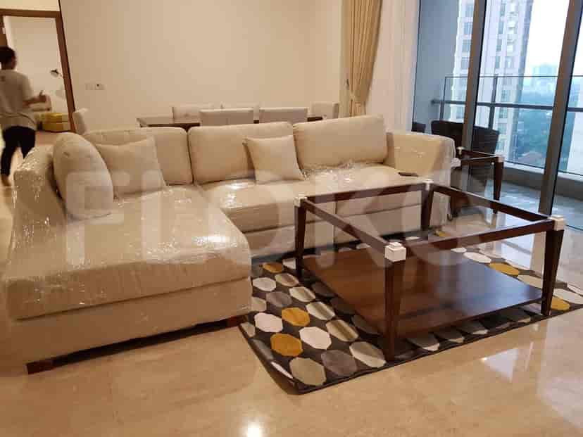 Spacious living area with an L-shaped sofa and a coffee table.