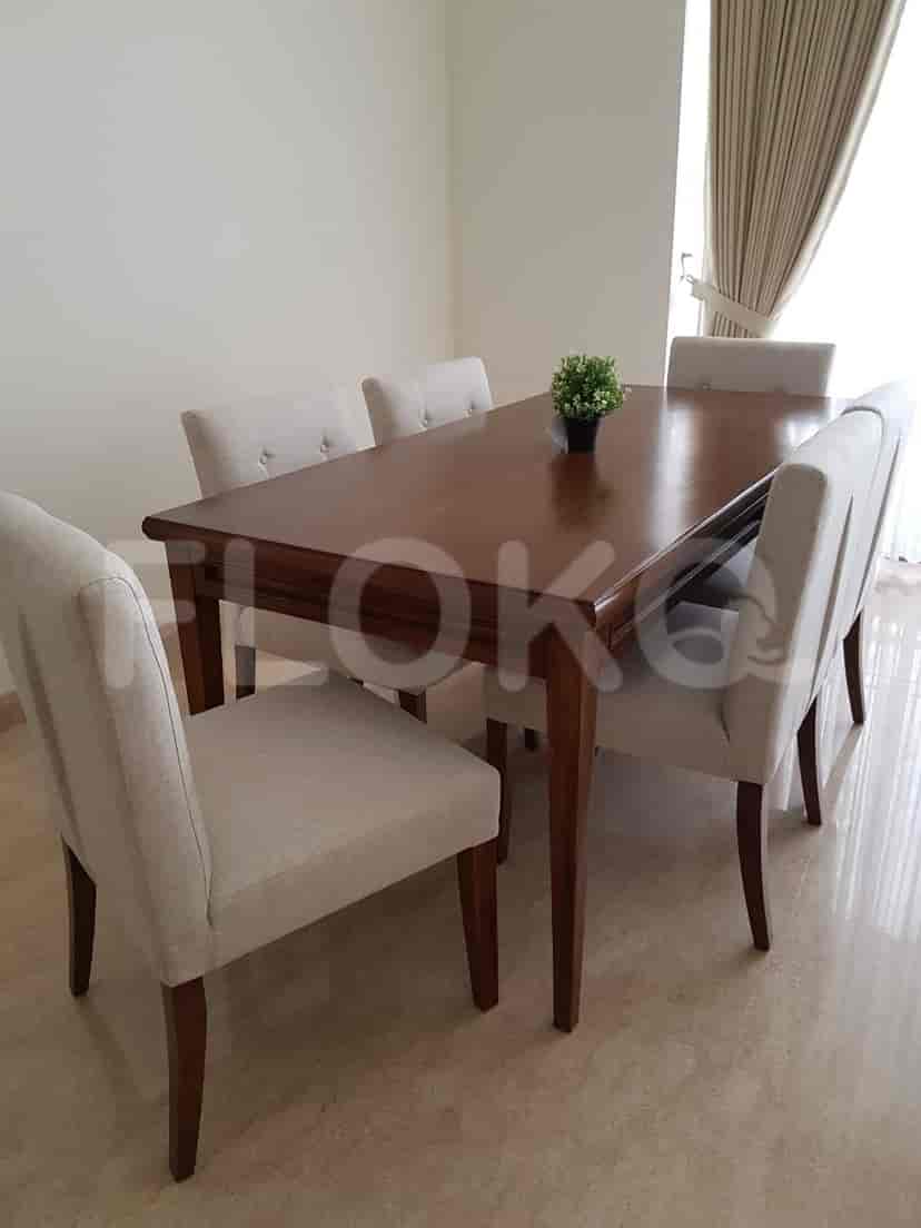 Dining area with a table, chairs, and a decorative plant.