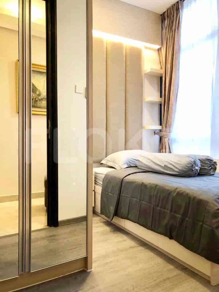 A well-designed bedroom featuring a bed, a large wardrobe, and elegant design.