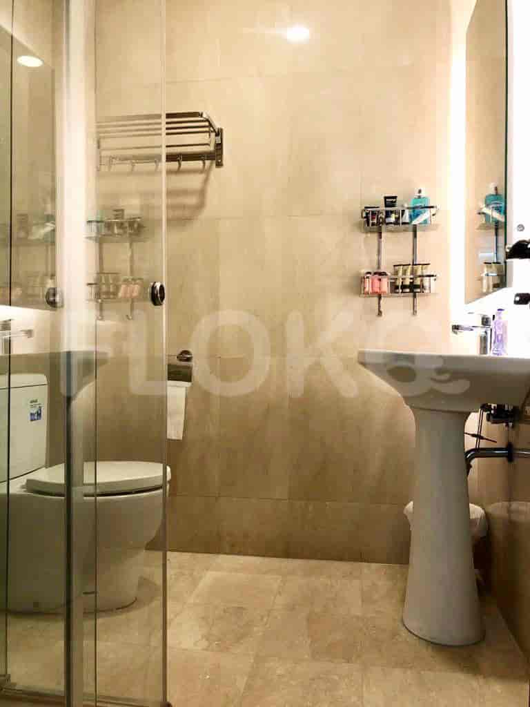 A clean and modern bathroom with a glass shower enclosure.