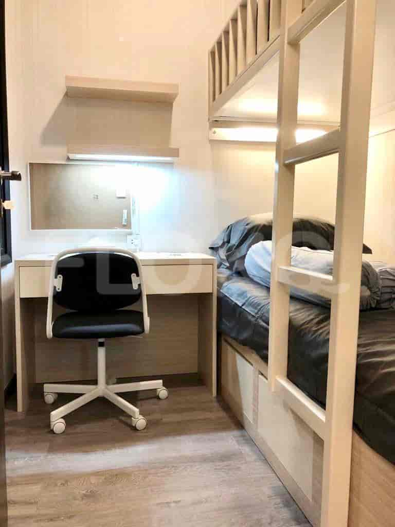 A kids room designed for both work and sleep, featuring a bunk bed and a desk.