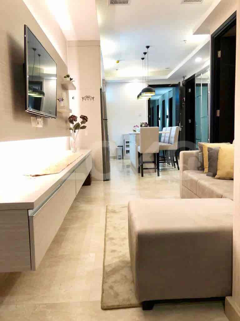 A stylish living space with a focus on clean lines, featuring a built-in TV unit.