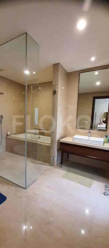 A modern bathroom with a bathtub, shower, and double vanity.