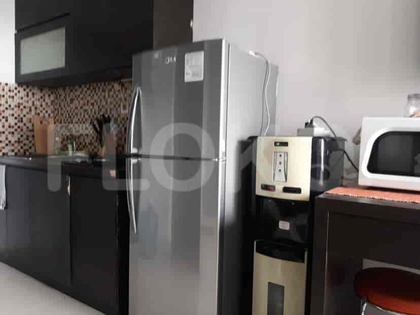 Kitchen with refrigerator and microwave.