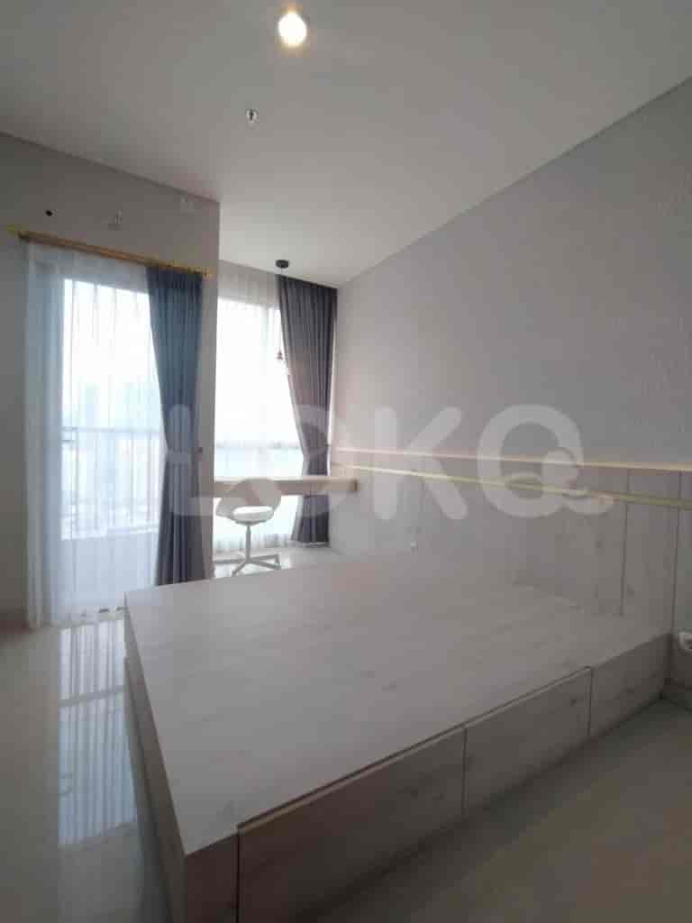 Bedroom with a low bed and wooden paneling.