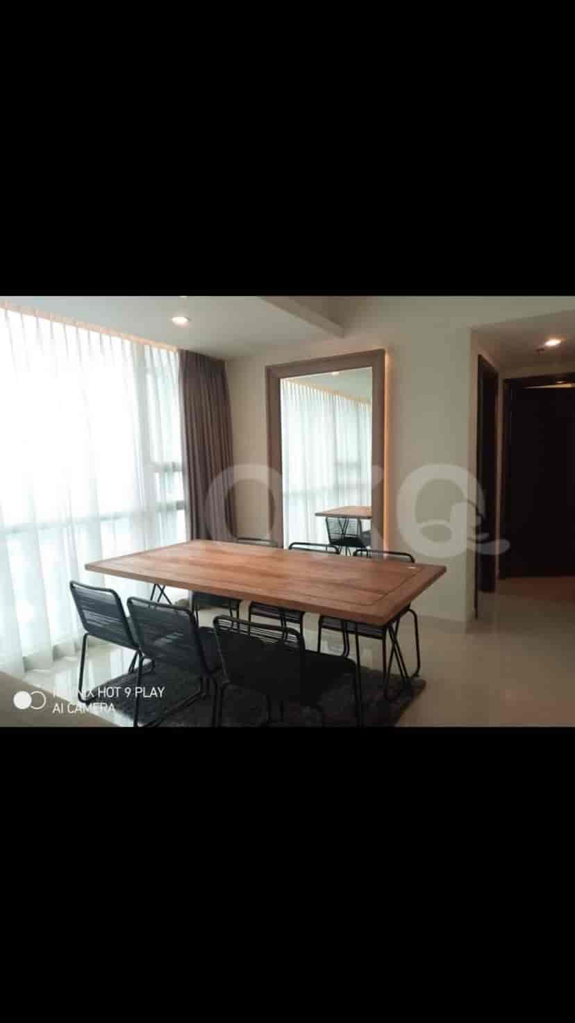 Dining area with a wooden table and modern chairs.