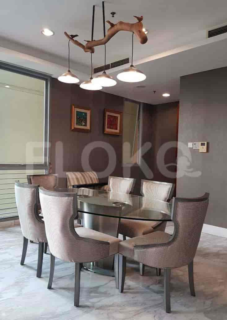 Dining room with a glass table and modern chairs.