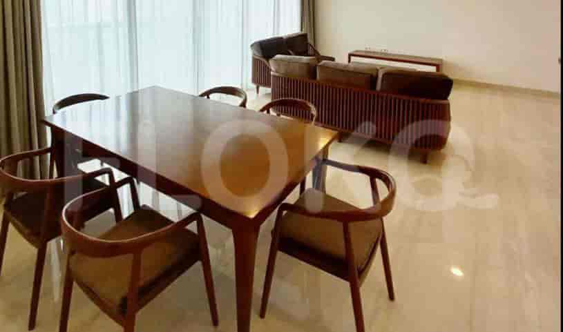 A dining table with chairs, a sofa, and additional seating.