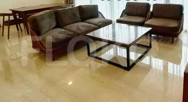 A living room with a sofa, armchairs, and a coffee table.