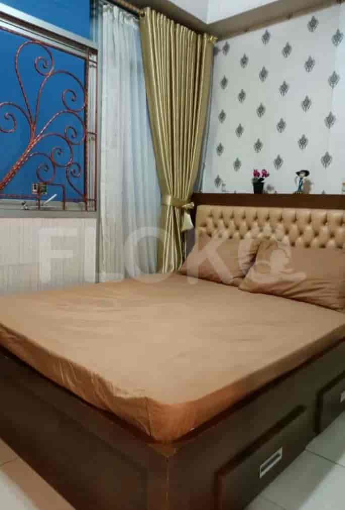 A master bedroom with a queen bed, large window, and neutral-toned decor.