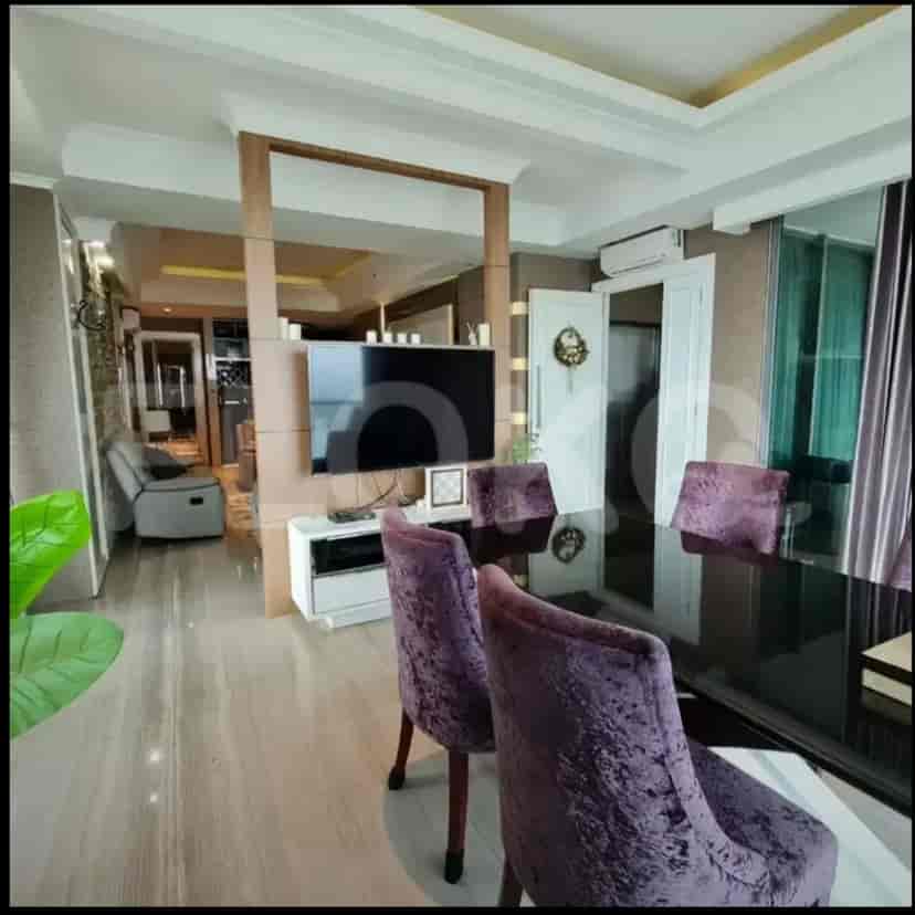 A combined dining and living area showcasing modern design with a smart TV.