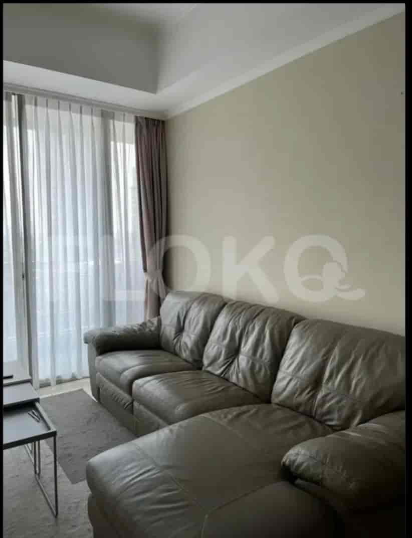 An open living room with a large L-shaped grey sofa.