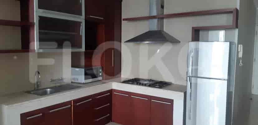 A modern kitchen with wooden cabinets, granite countertops, and stainless steel appliances.