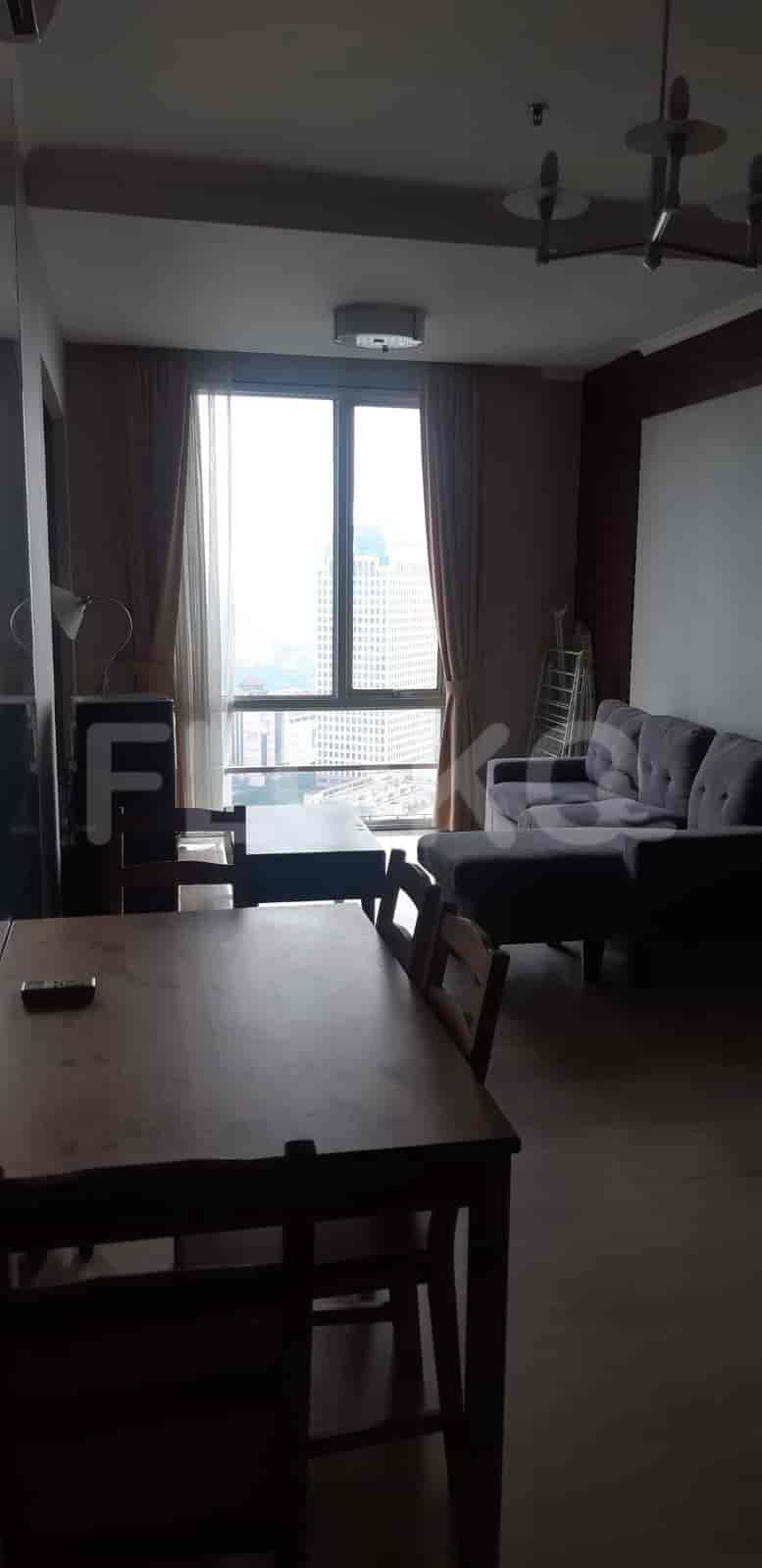 A combined living and dining area with city view.
