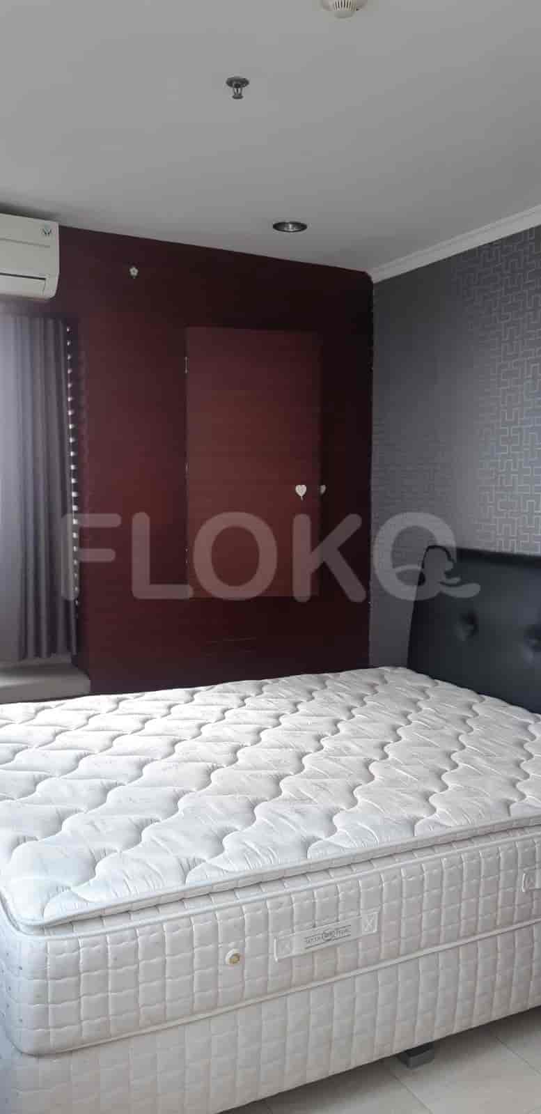 A modern bedroom with a double bed and wooden panels.