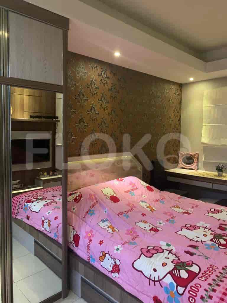 Bedroom with Hello Kitty-themed bed, wall-mounted TV, and a mirror closet.