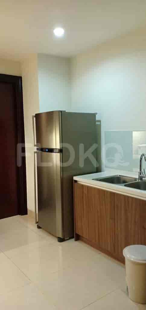A compact kitchen with a refrigerator and a sink area.