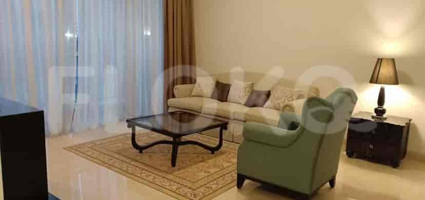 A living room featuring a sofa, armchair, and a coffee table.