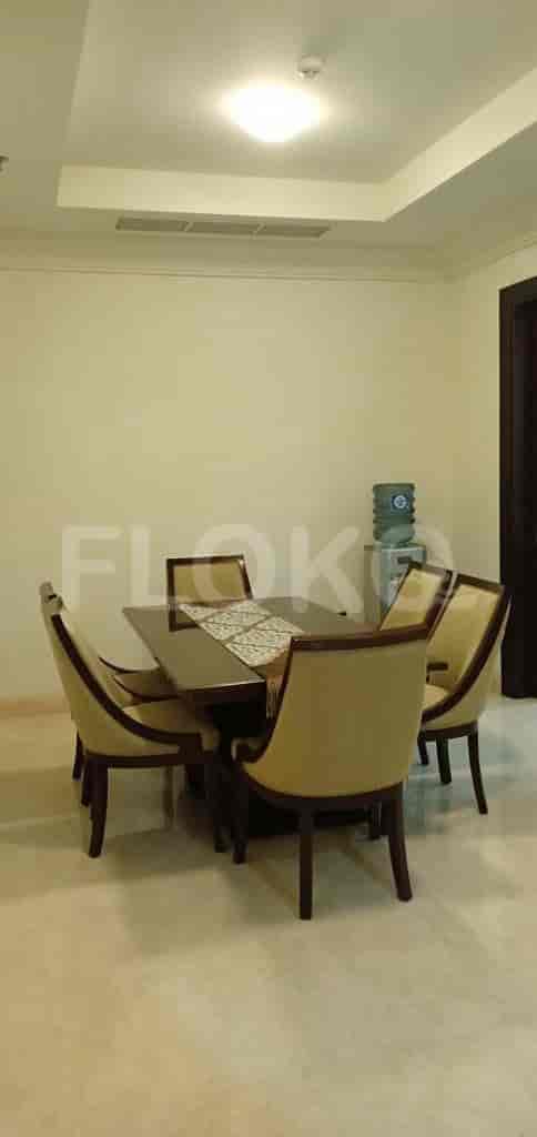 A dining area with a dining table and six chairs.