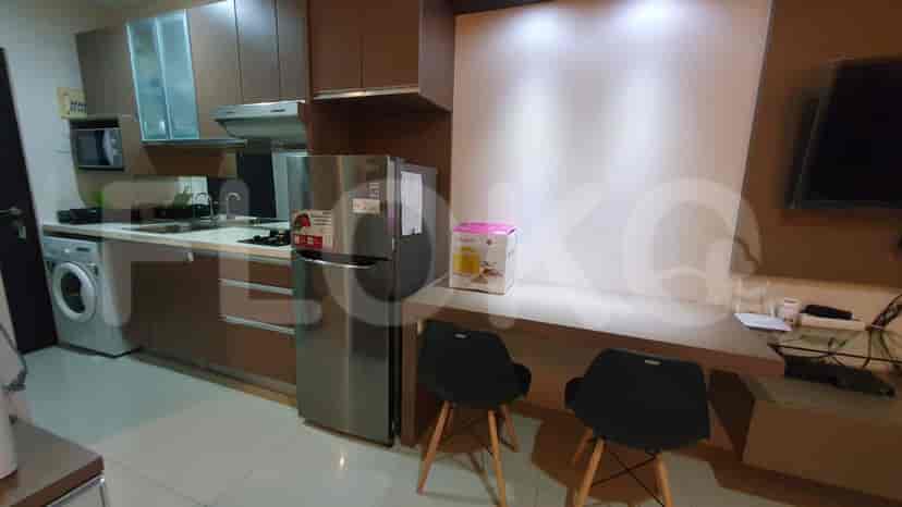 A modern kitchen with stainless steel appliances and wooden cabinetry.
