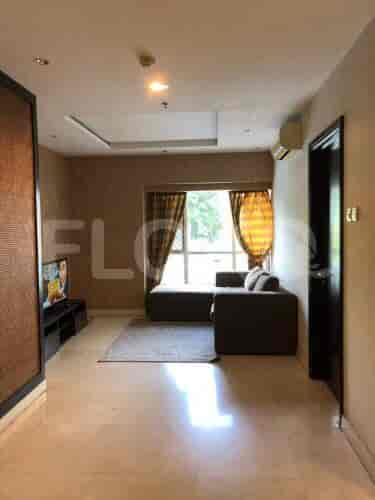 Living area with a grey sofa, TV, and dining space visible.