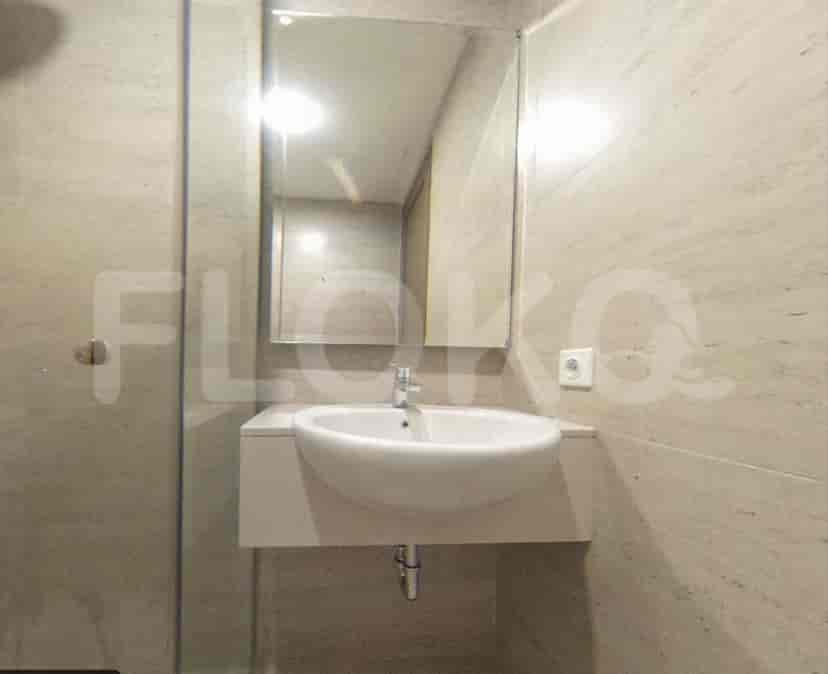 A bathroom with a sink, mirror, and tiled walls.