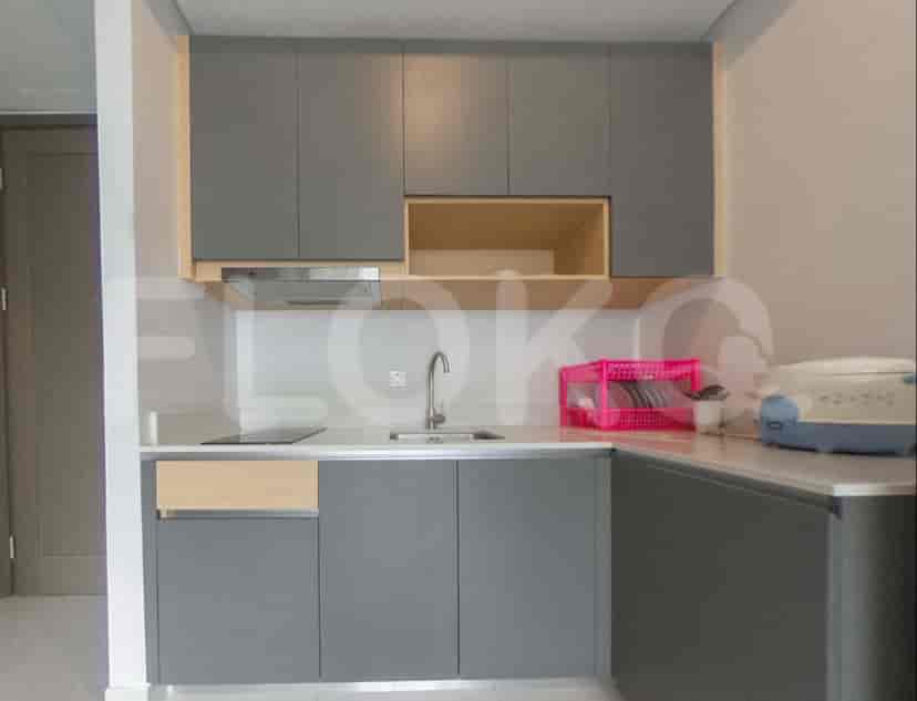 A modern kitchen with upper and lower cabinets, a sink, and an electric stove.