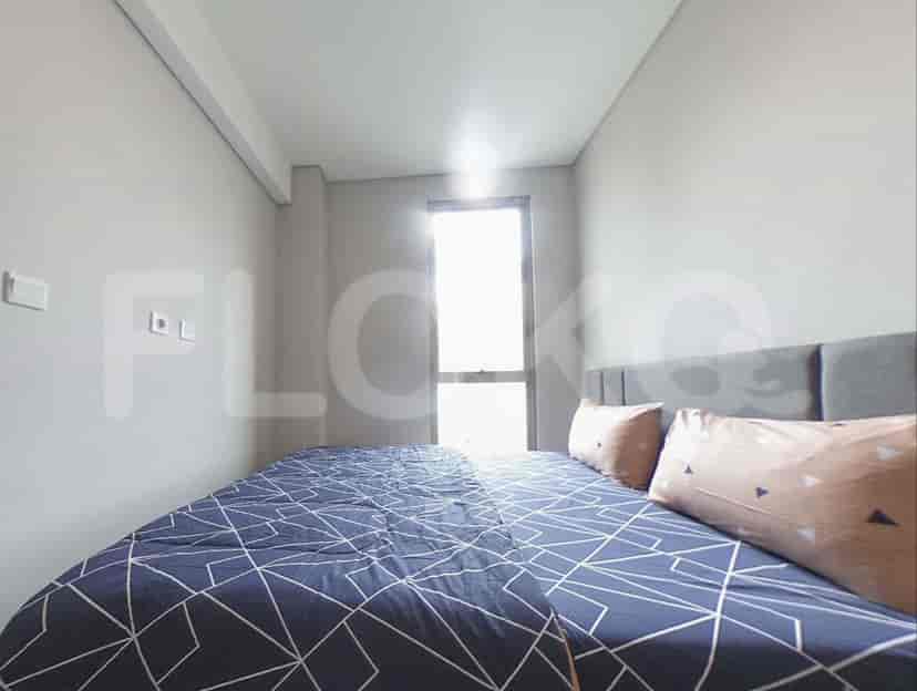 A simple bedroom with a bed and a window.