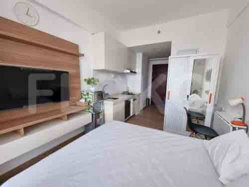 A studio apartment blending a bedroom with a kitchenette for efficient living.