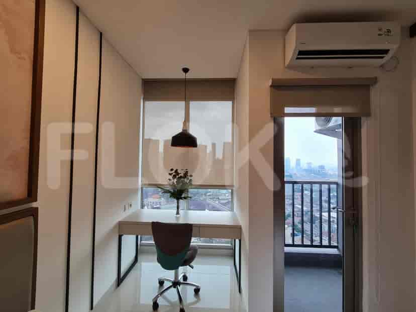 A home office setup with a desk, chair, and city view.