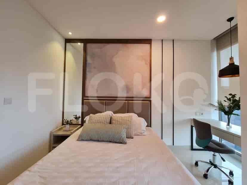 A stylish bedroom with a bed, artwork, and home office.
