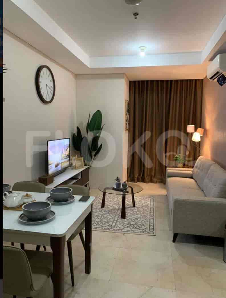 A view of a living area including a dining table and TV.