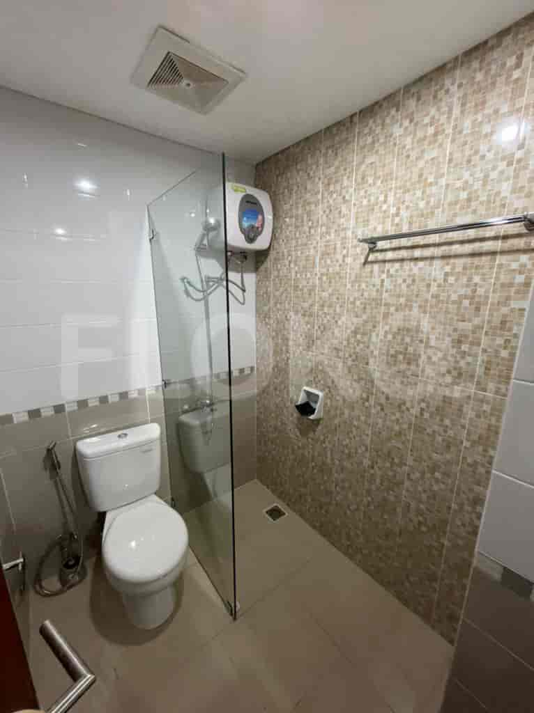 Bathroom with toilet, shower, and sink.