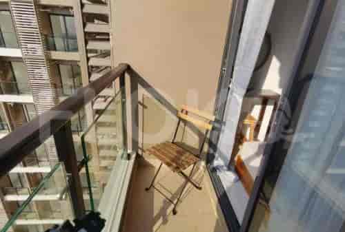 A small balcony with seating and a view.