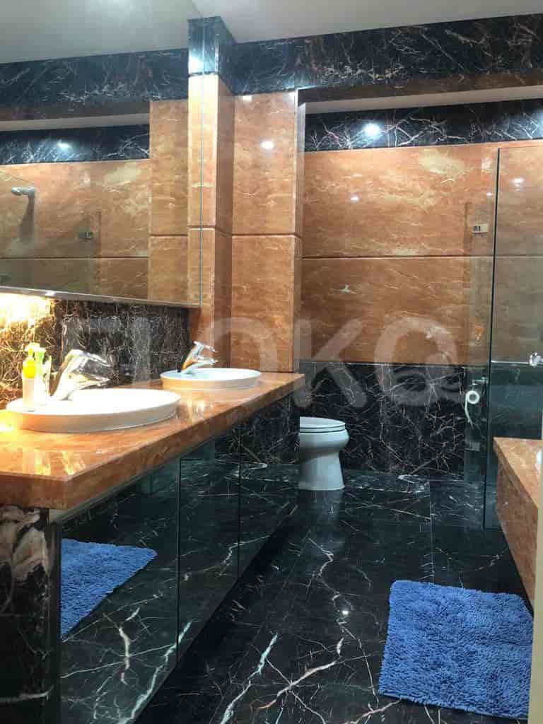 A luxurious bathroom with marble walls.