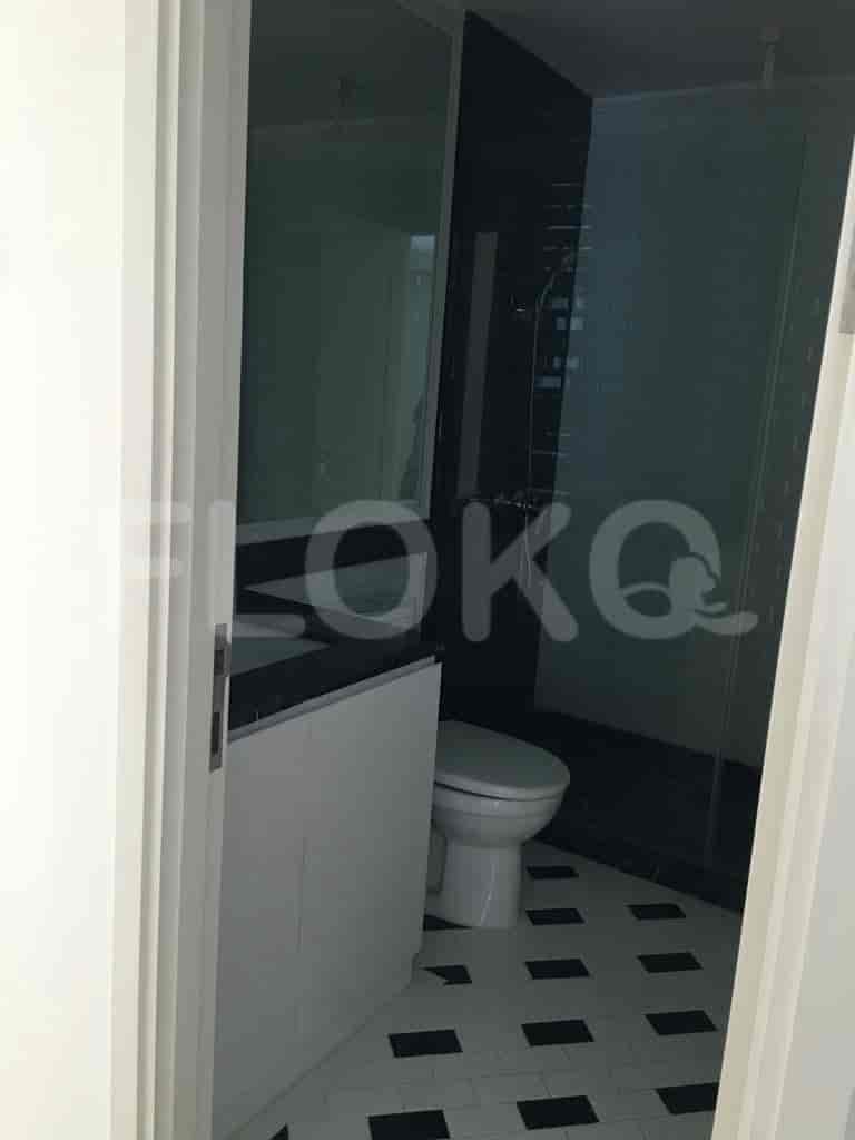 A modern bathroom with a toilet, a shower, and a vanity.