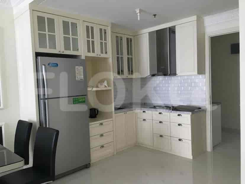 A modern kitchen with cabinets, a refrigerator, and a stove.