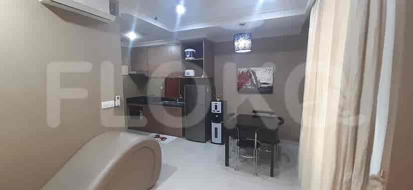 A modern kitchen with cabinets, appliances, and a dining area.