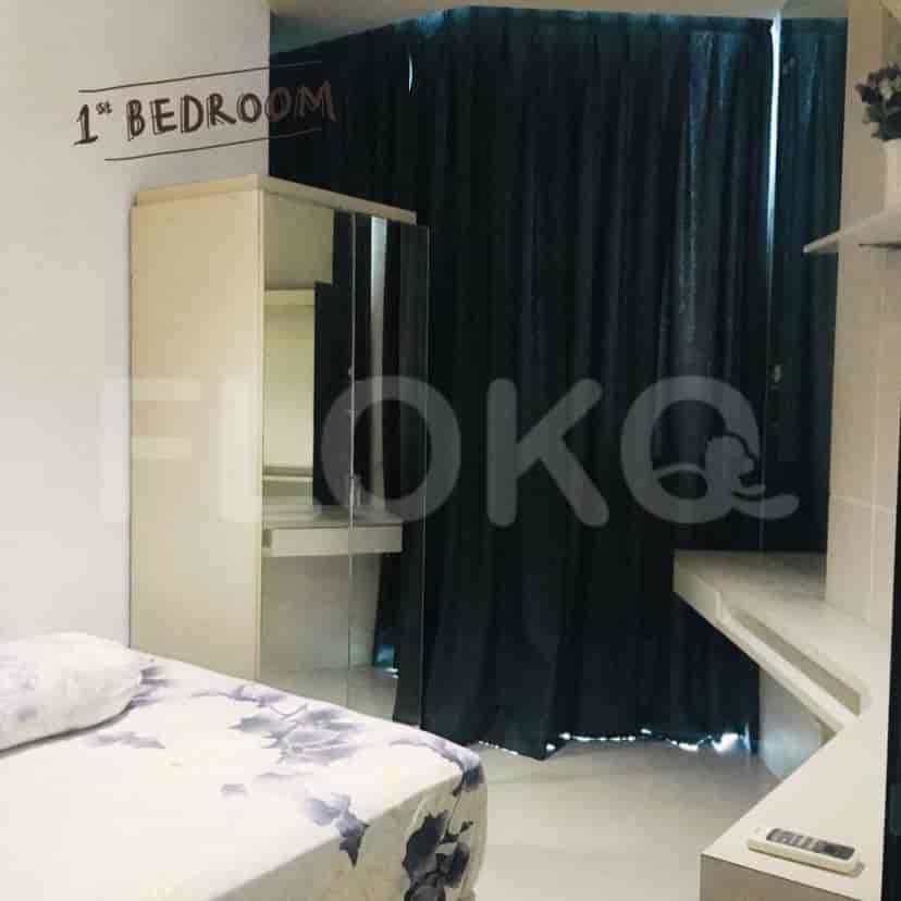 A bedroom with a bed, wardrobe, and desk.